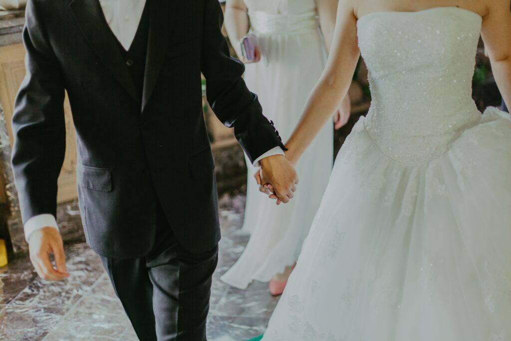 Bride and groom walking by holding hand