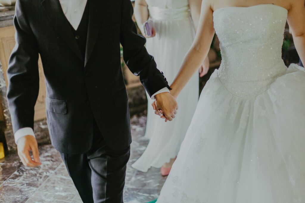 Bride holding hands groom